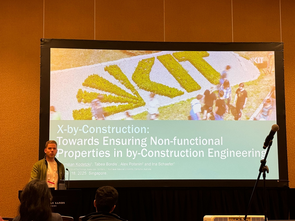 A person is giving a presentation at the OOPSLA conference.